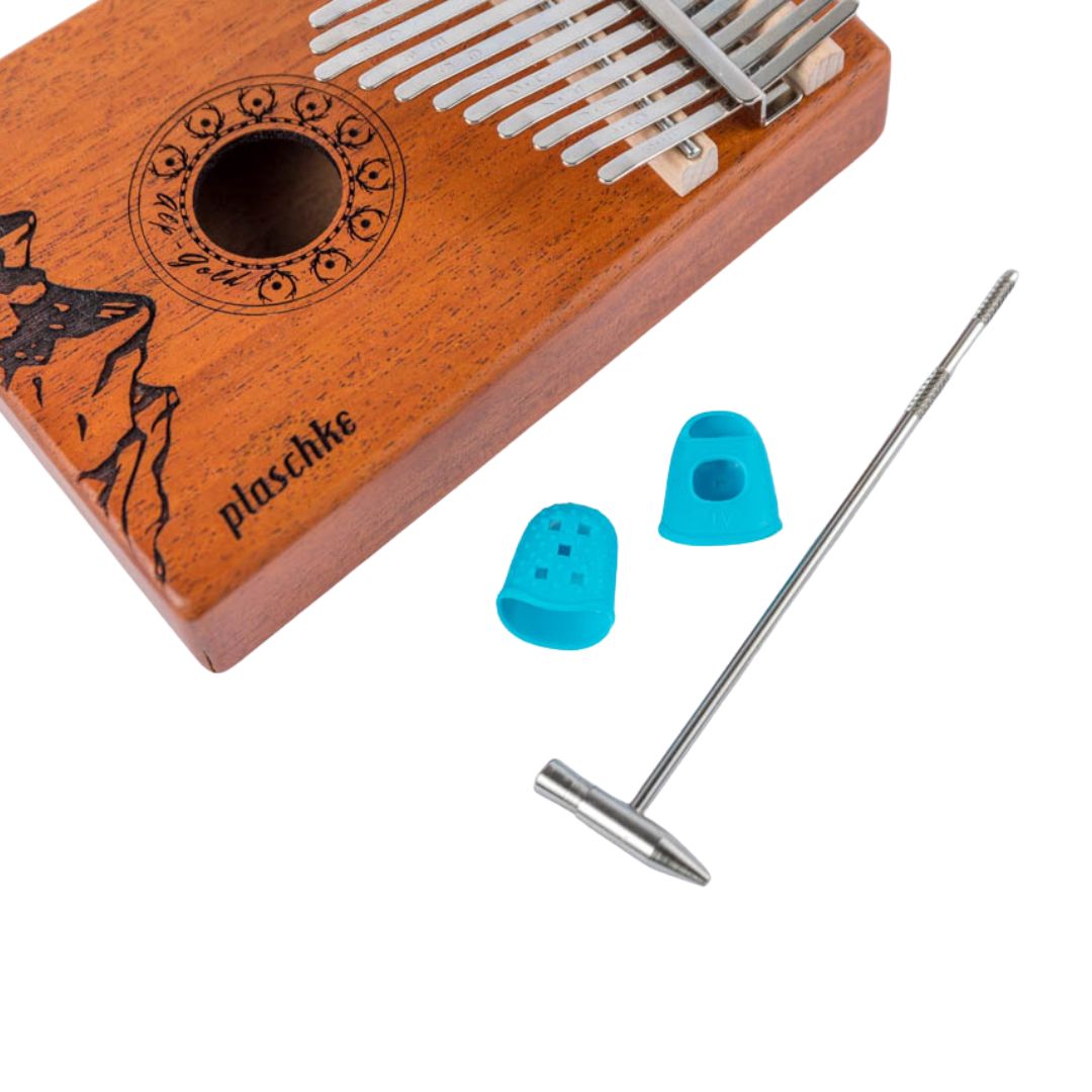 Übersichtsdarstellung des Kalimba-Zubehörs mit Erklärungen zu Fingerschutz und Stimmhammer.