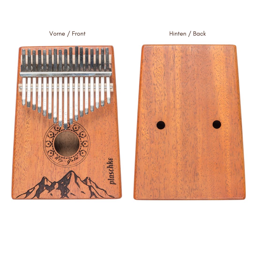 Gegenüberstellung der Vorderseite mit Berg-Gravur und der glatten Rückseite des Daumenklaviers zur Ansicht der Holzmaserung